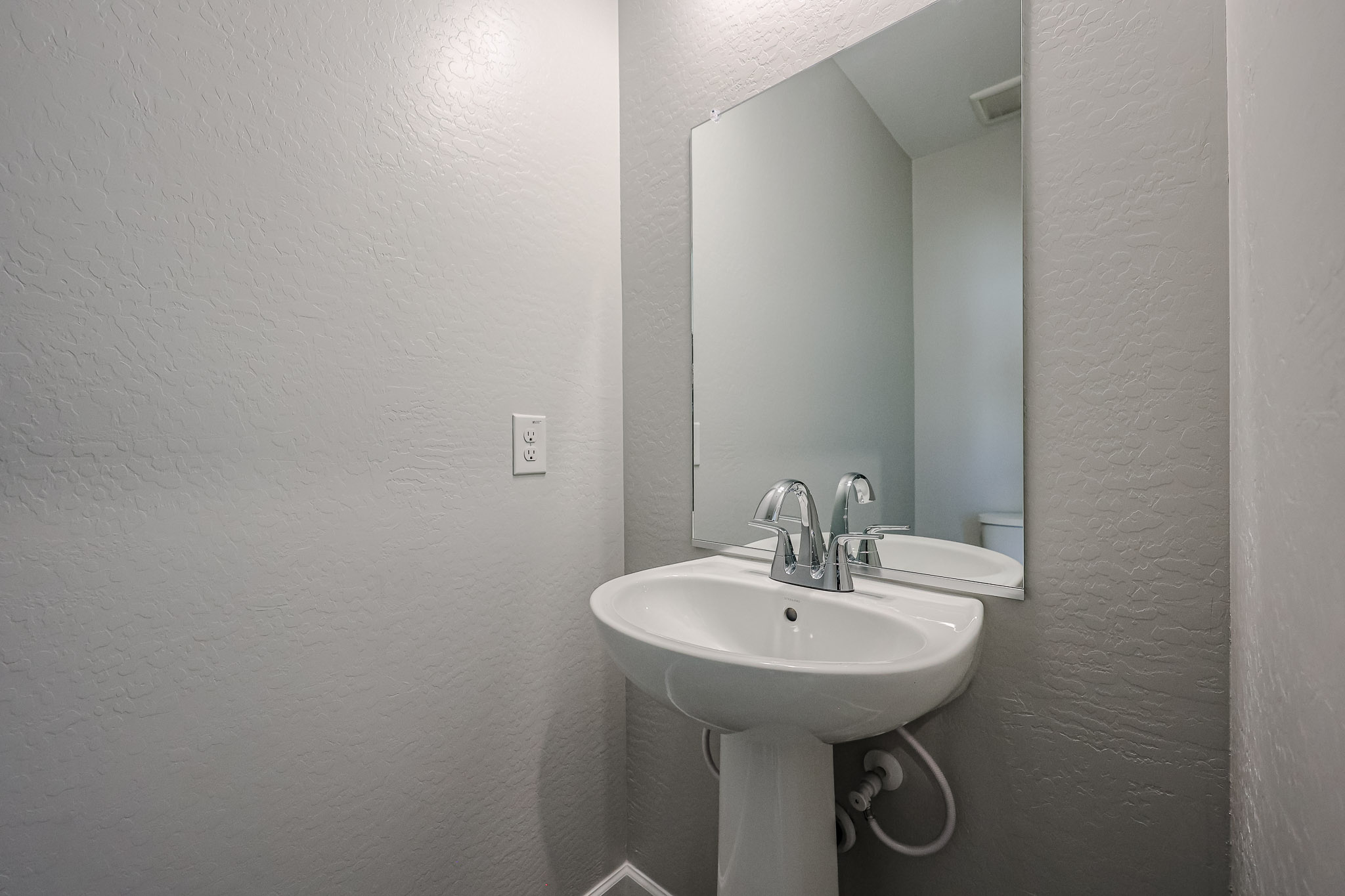A bathroom with a sink and mirror.