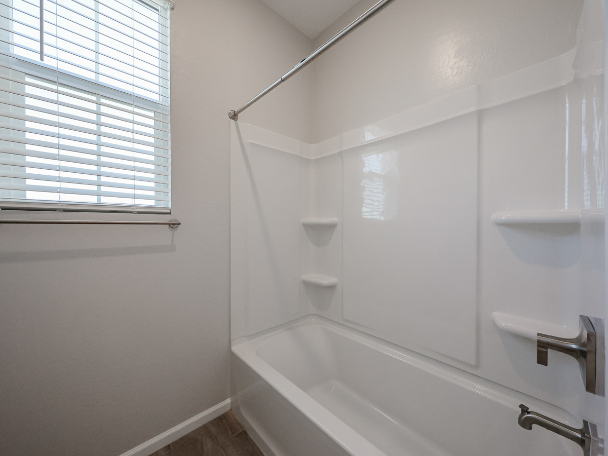 A bathroom with a bathtub and sink.