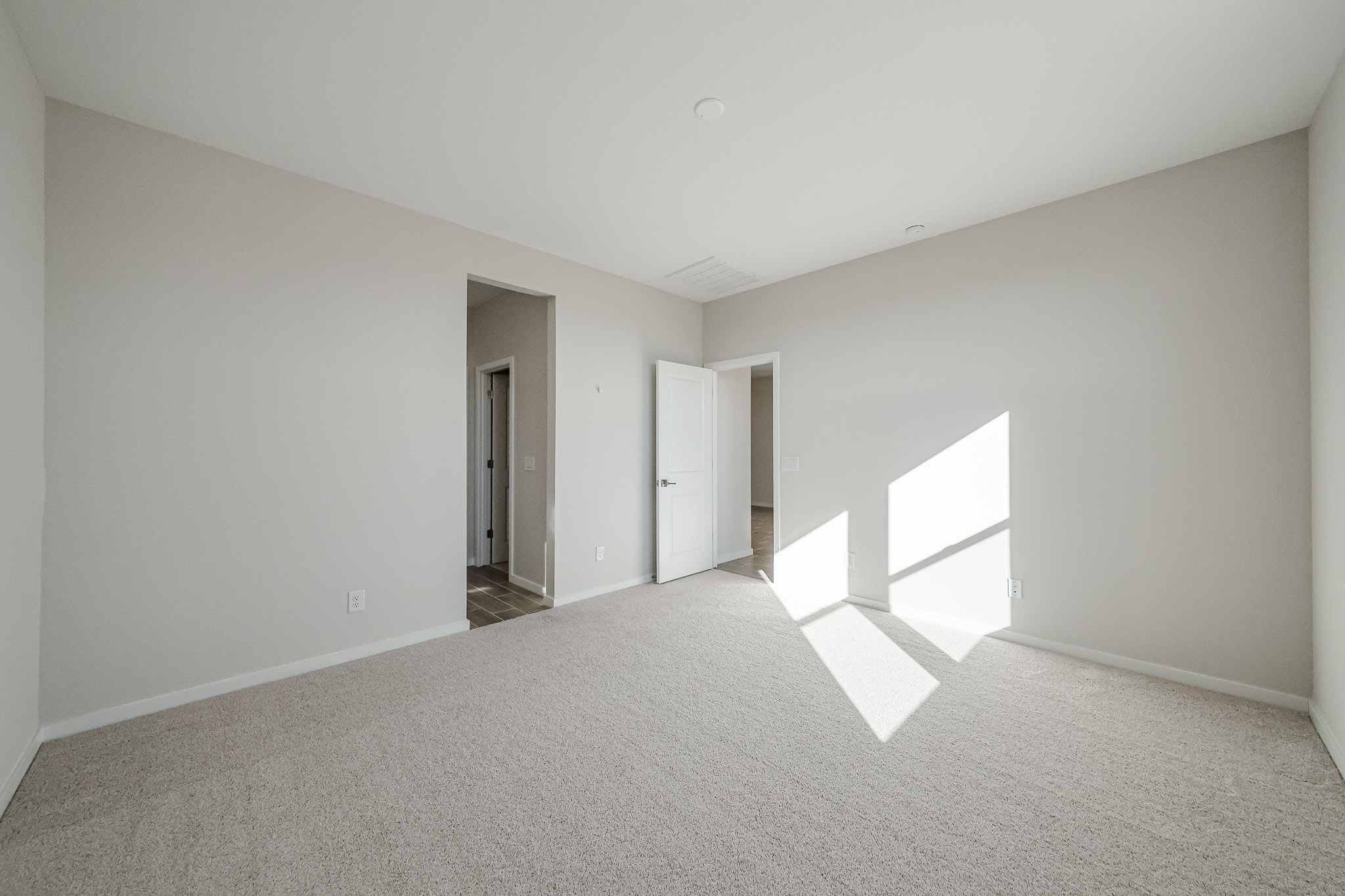 A long hallway with white walls.