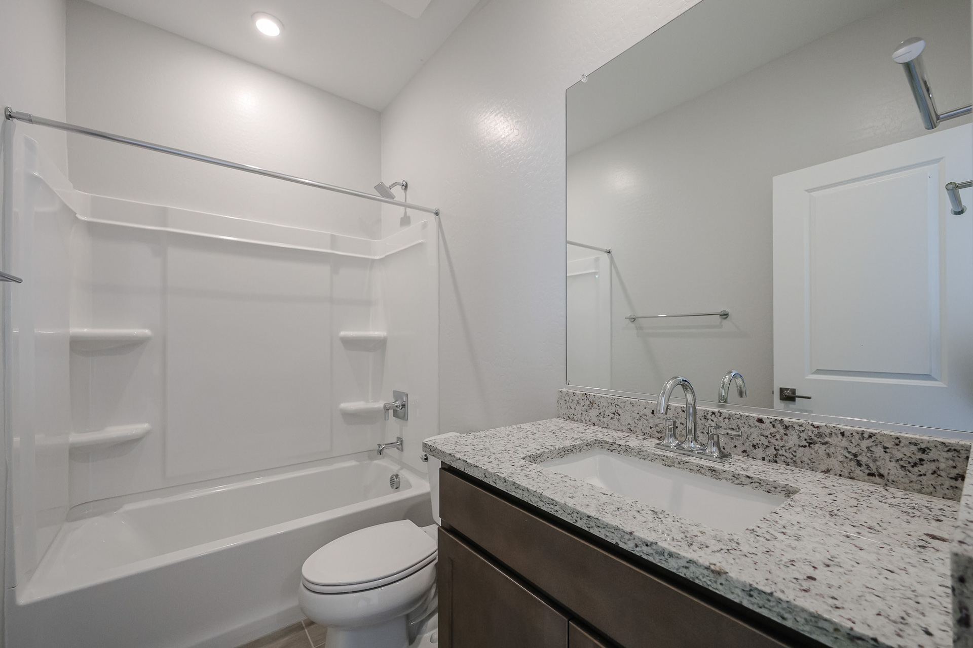 A bathroom with a marble countertop.