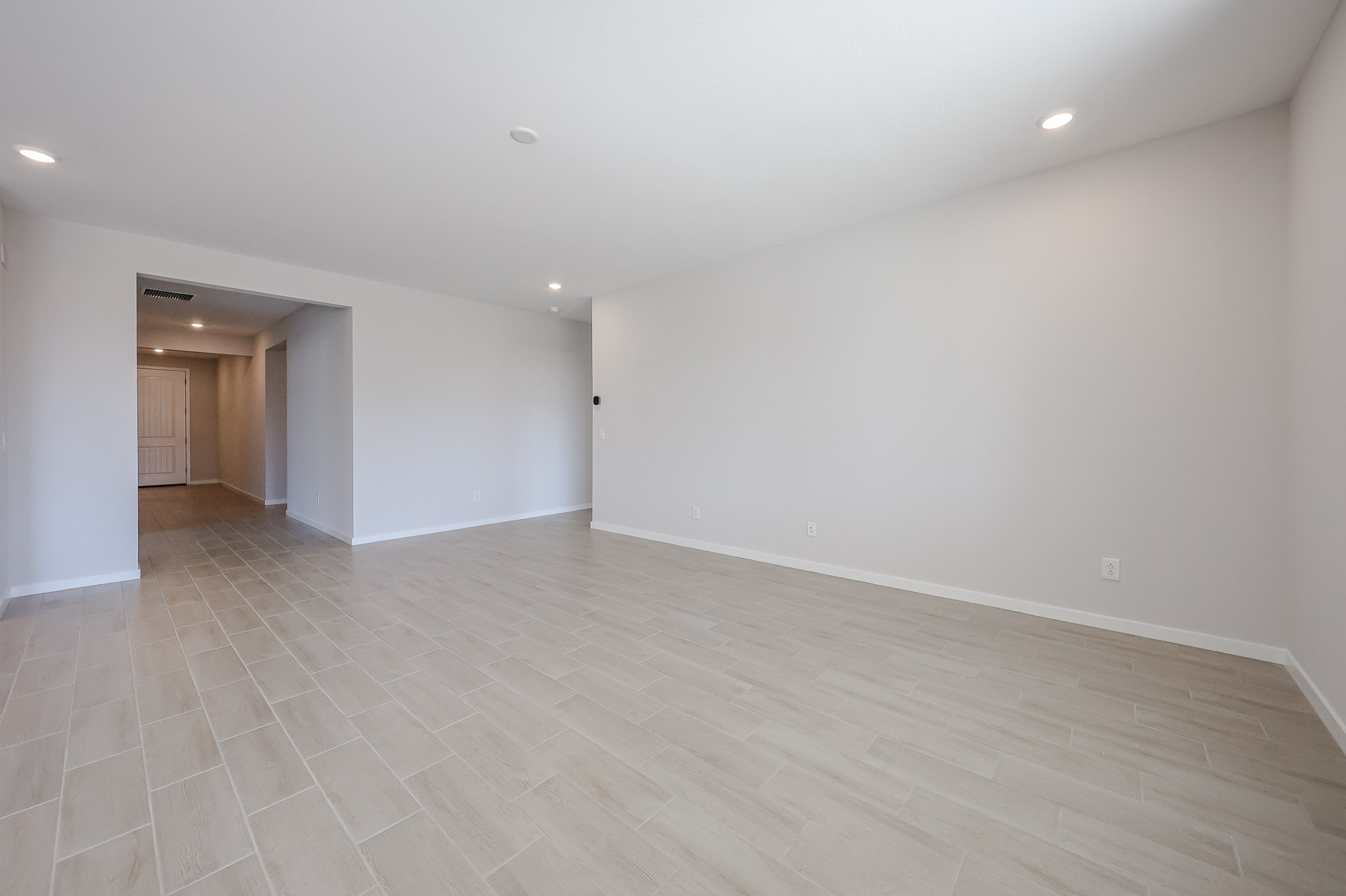 A room with a wood floor and white walls.