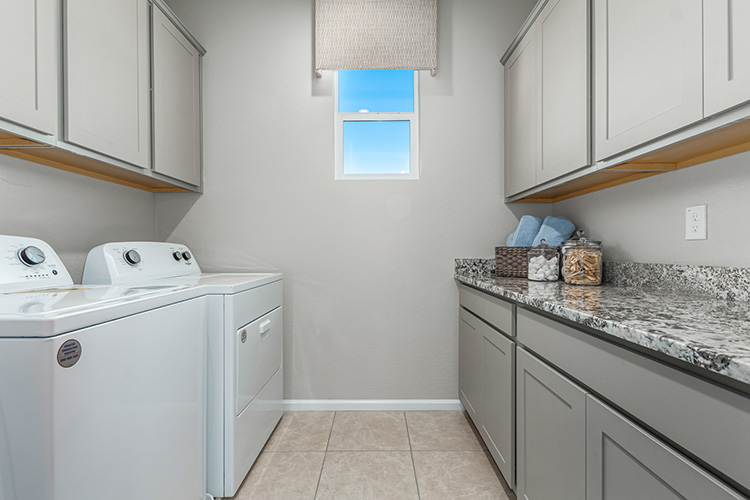 A kitchen with white cabinets.