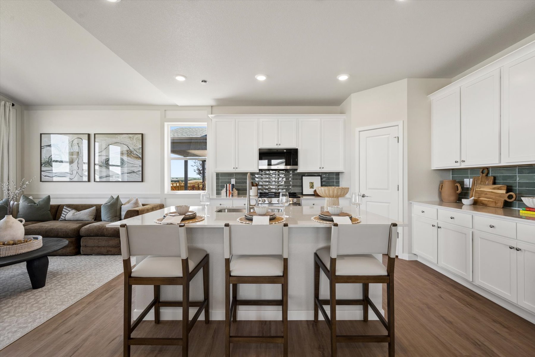A kitchen with white cabinets.