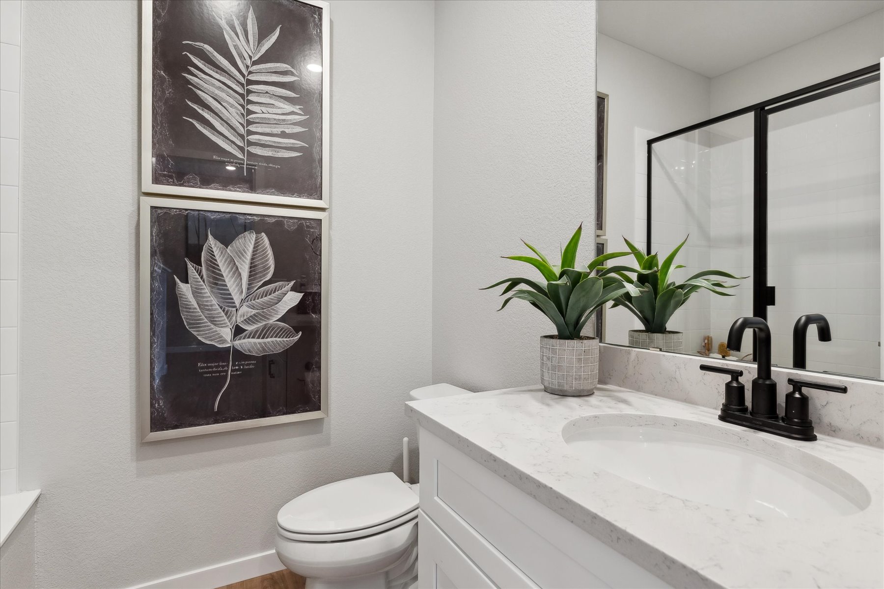 A bathroom with a sink and a toilet.