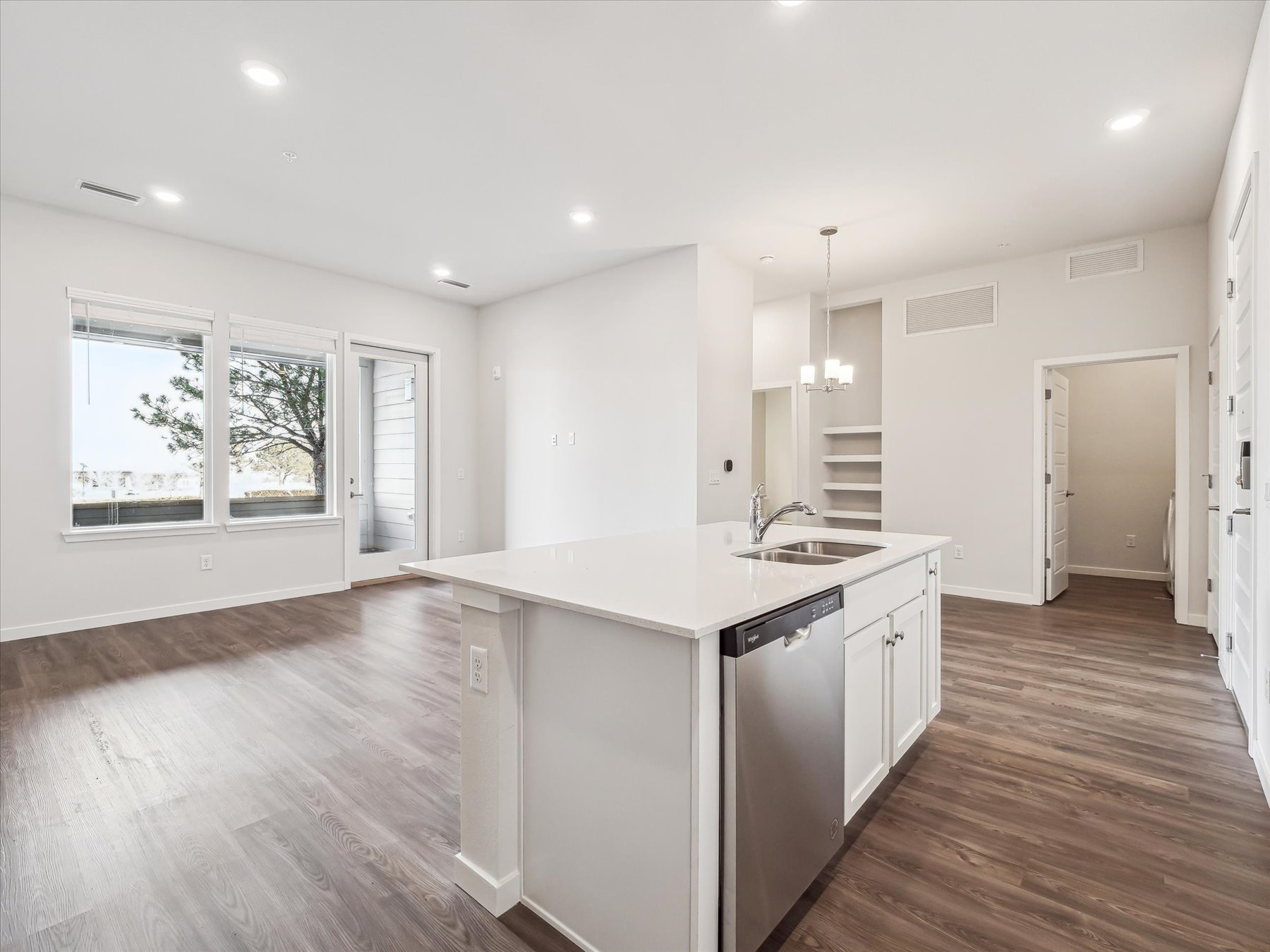 A kitchen with white cabinets.