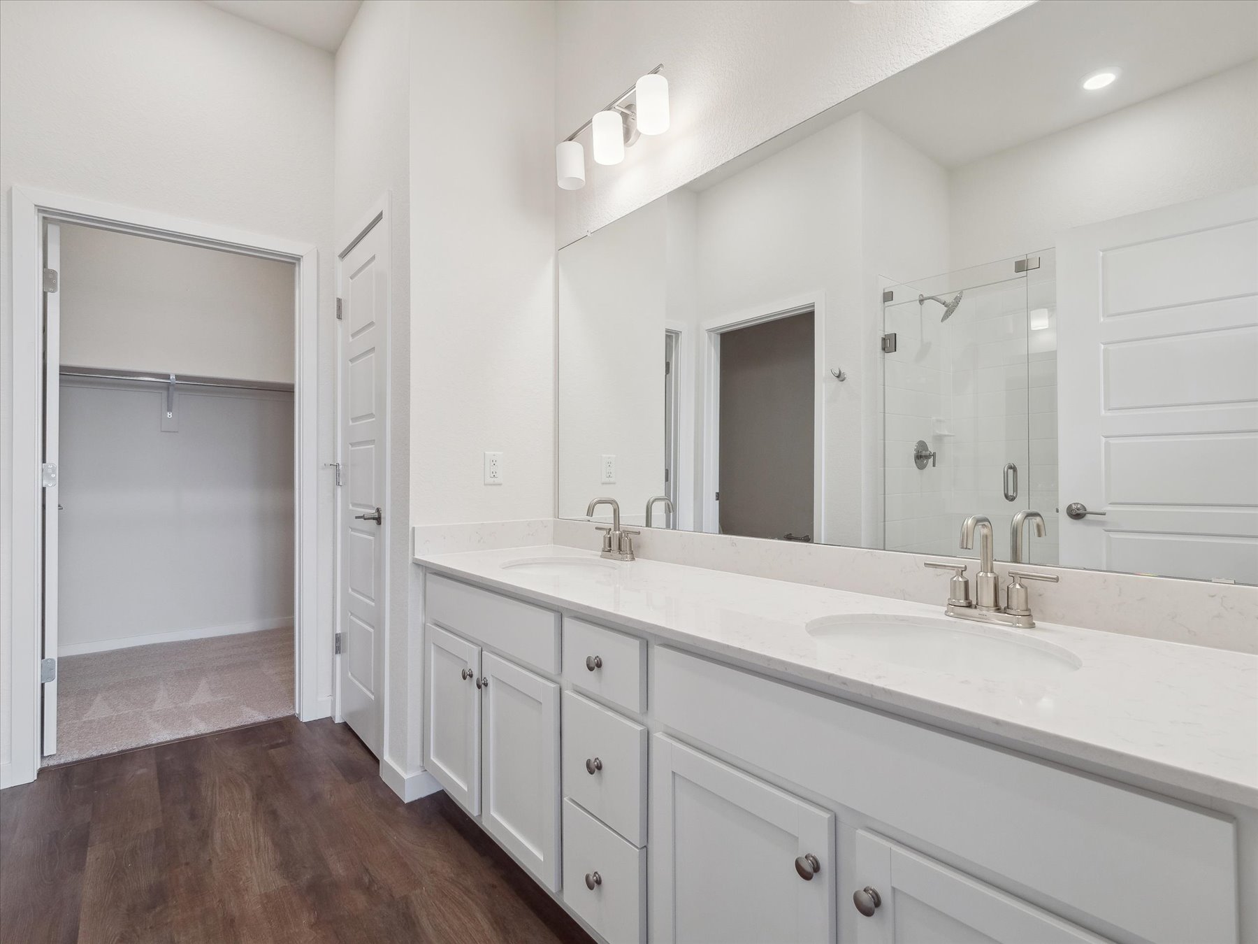 A bathroom with a large mirror.