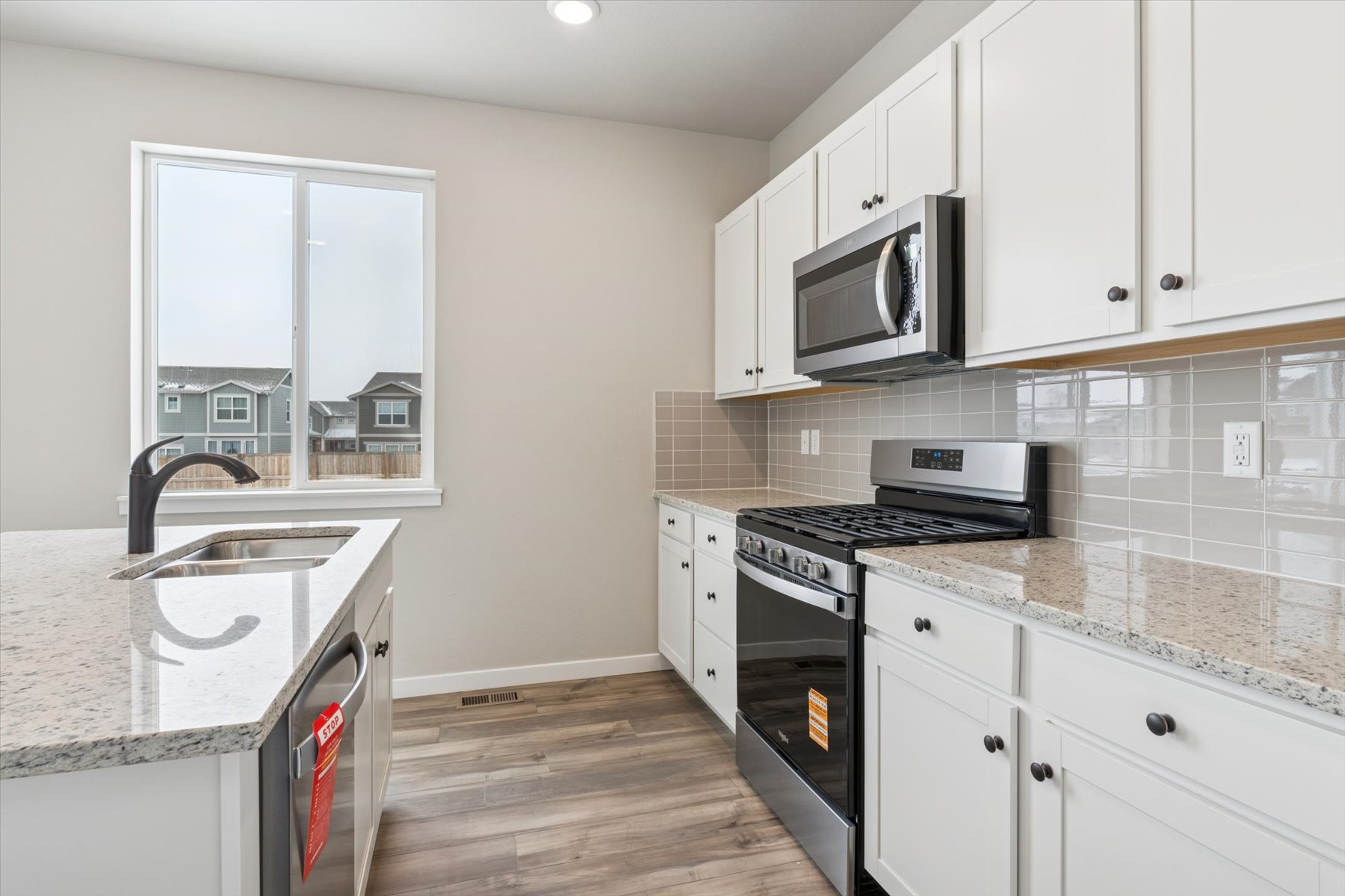 A kitchen with white cabinets.