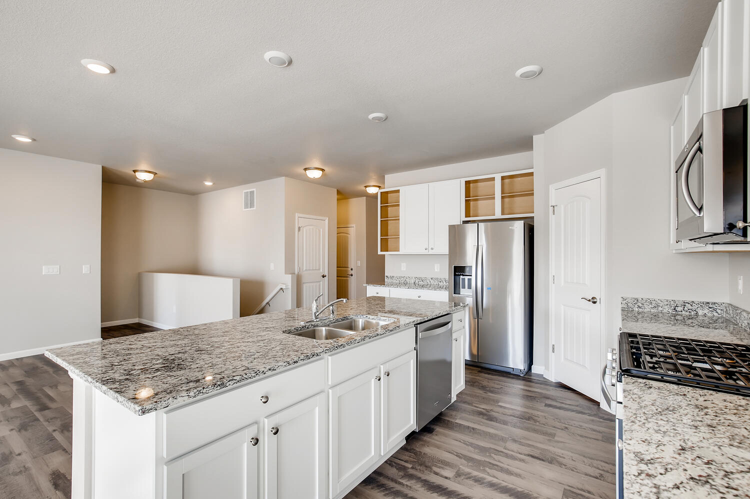 A kitchen with white cabinets.