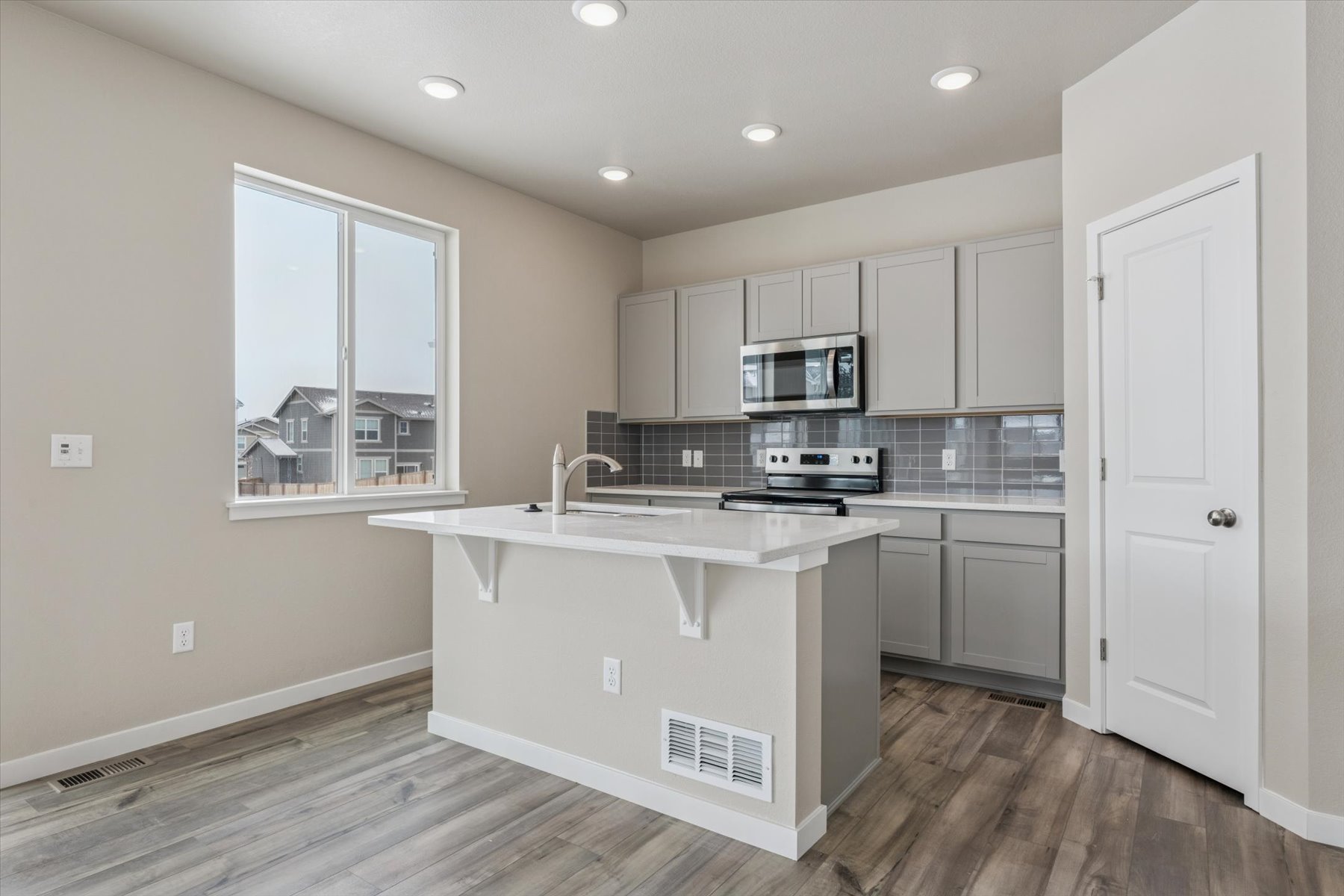 A kitchen with white cabinets.