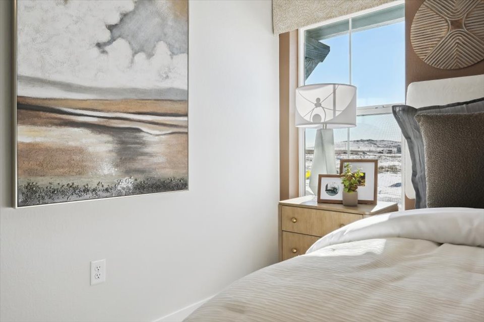 A bedroom with a large window.