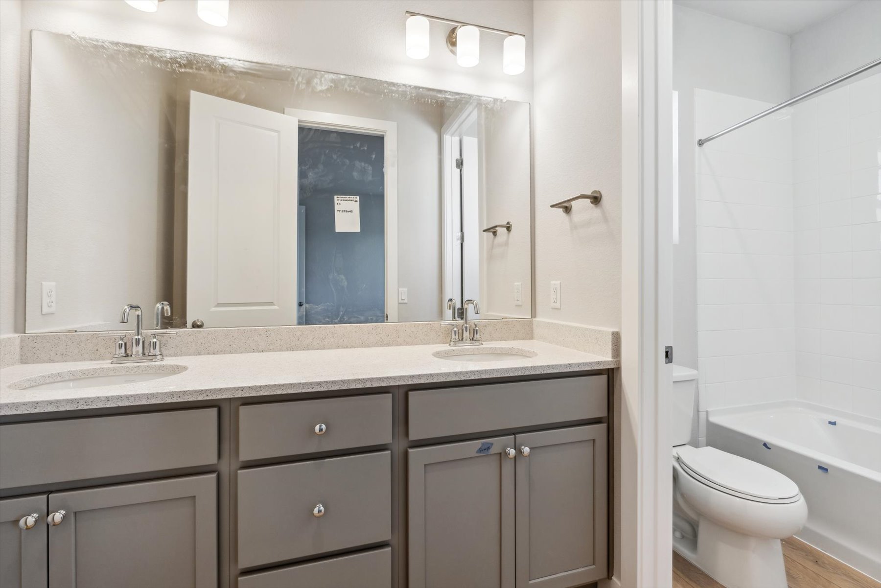 A bathroom with a large mirror.