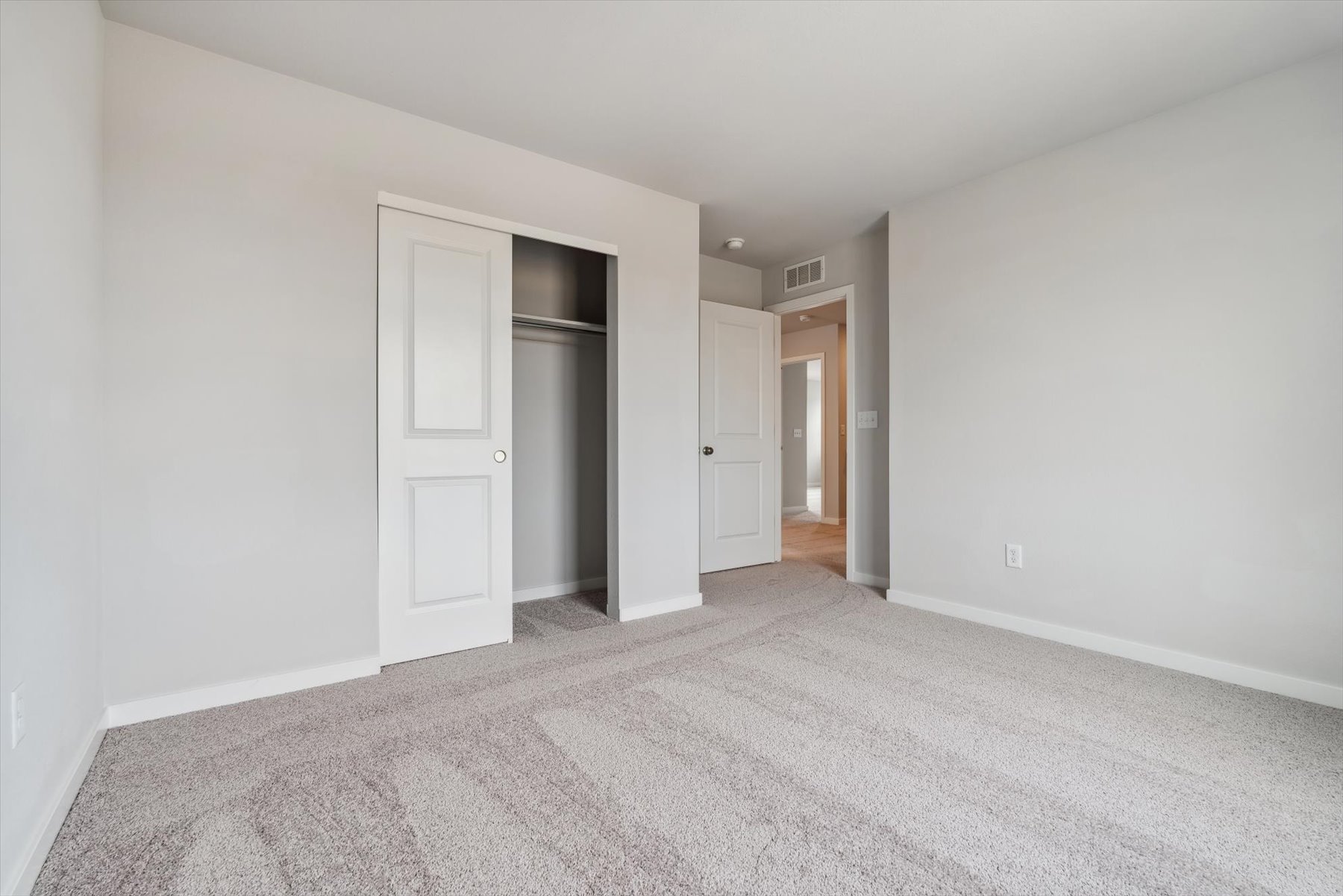 A hallway with white walls.