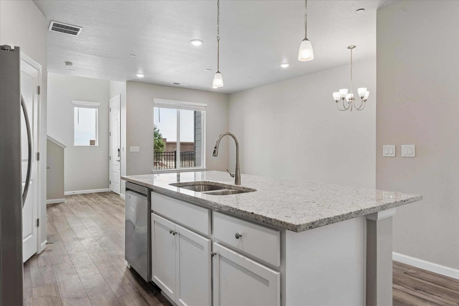 A kitchen with marble counters.