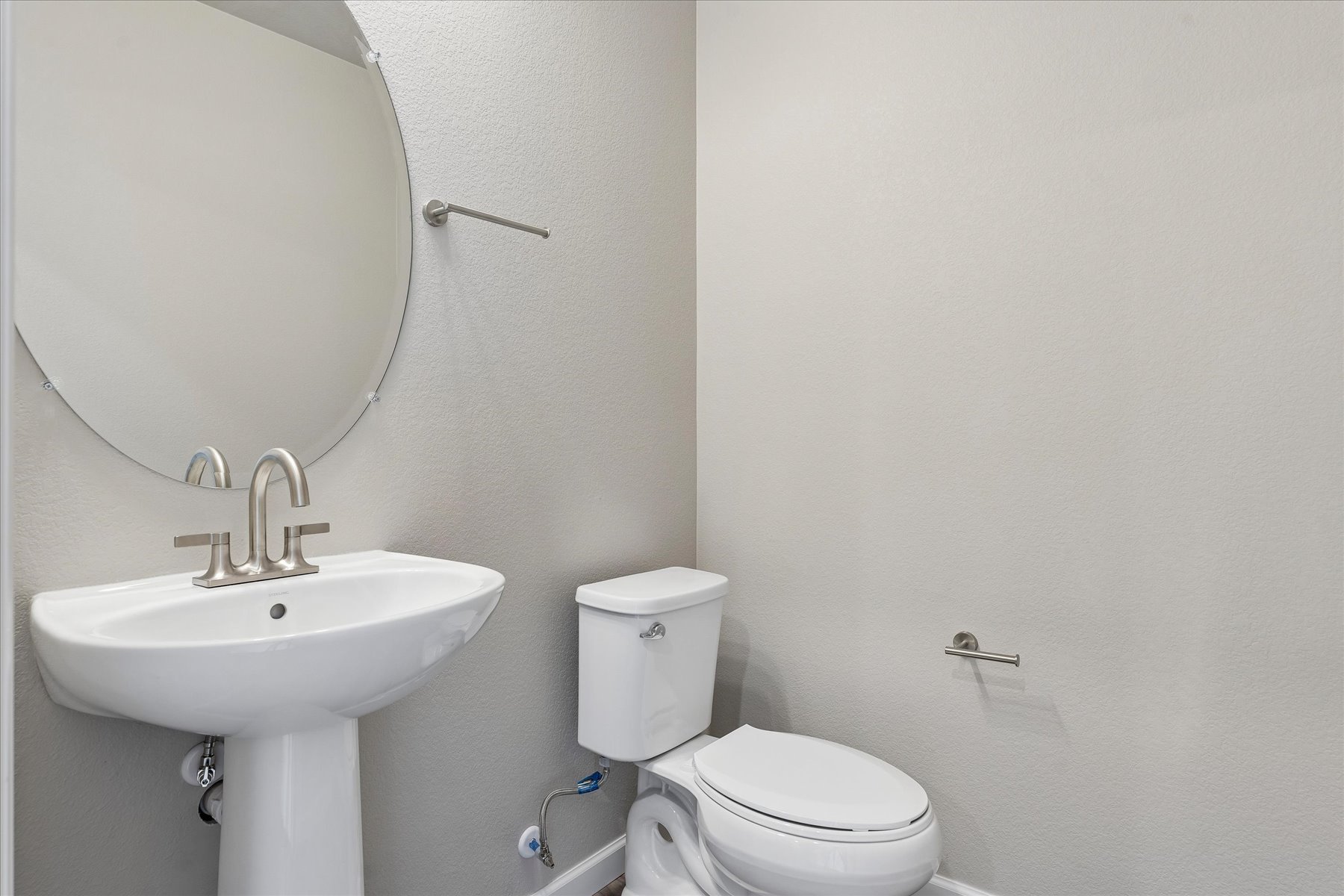 A bathroom with a toilet and sink.