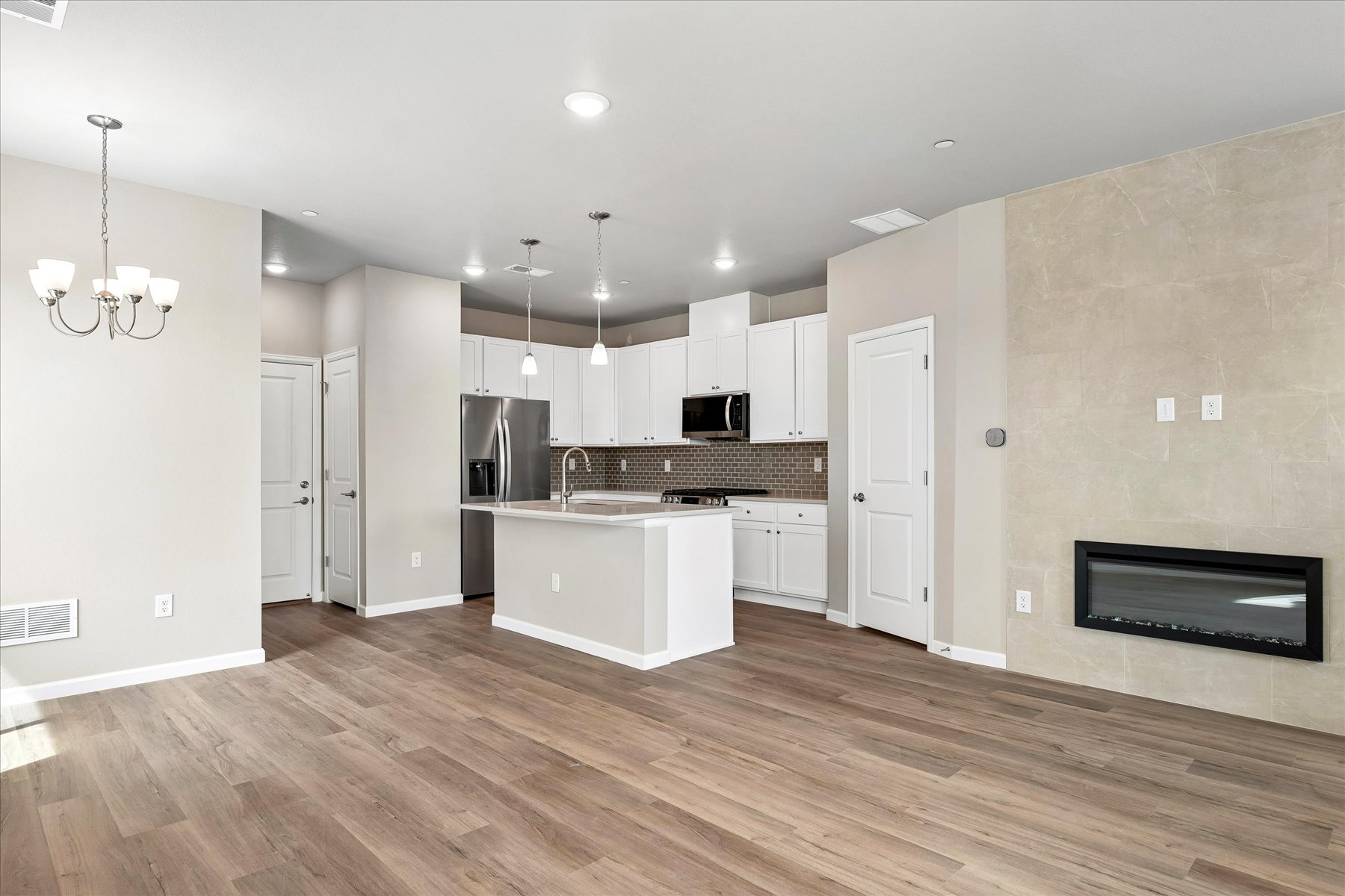 A kitchen with white cabinets.