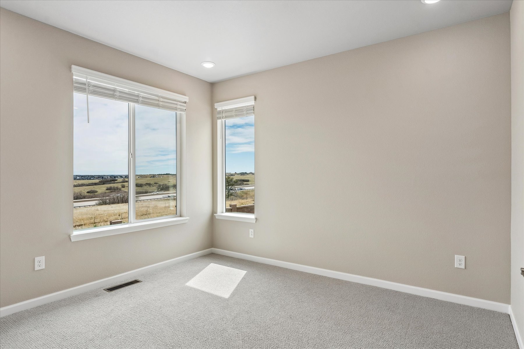 A room with a window and a vent.