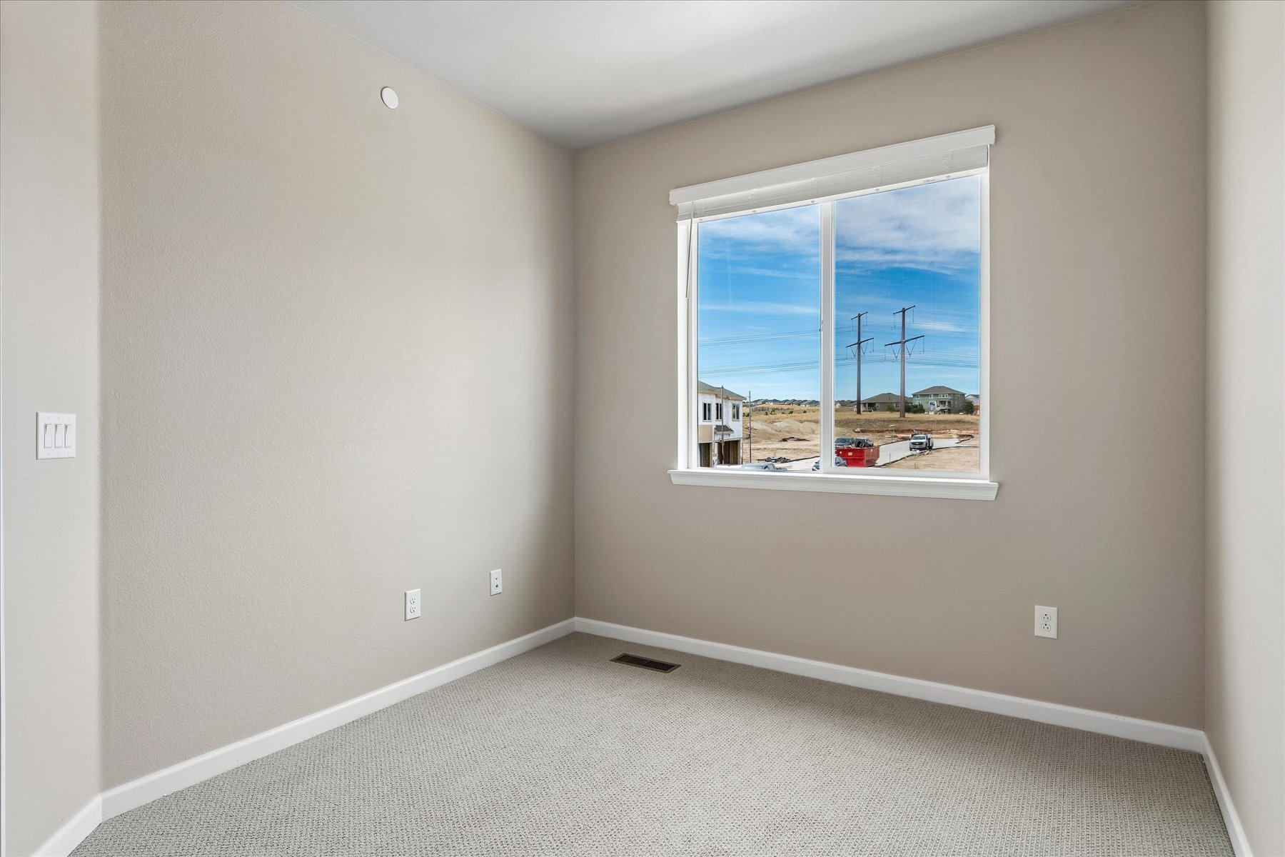 A room with a window and a view of the ocean.