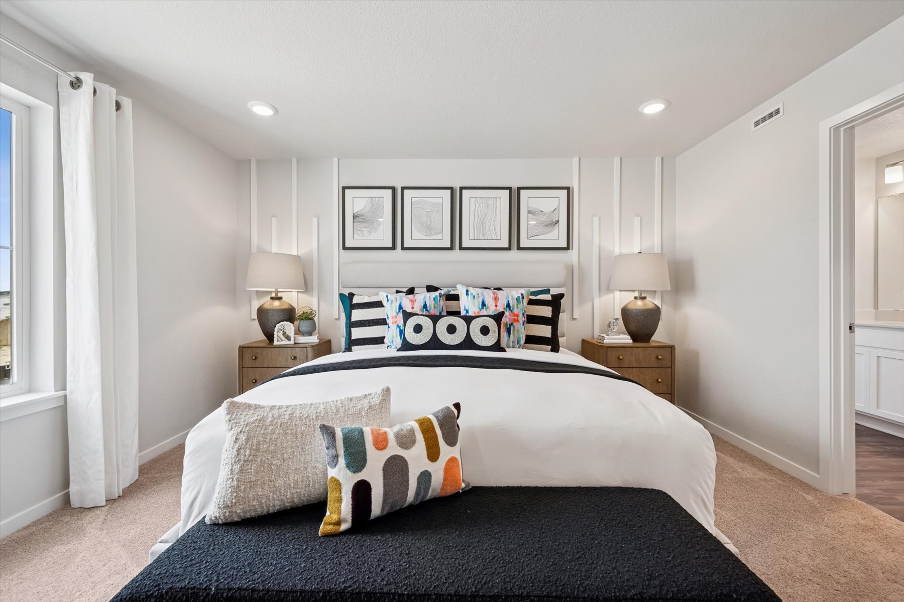 A bedroom with a bed and lamps.