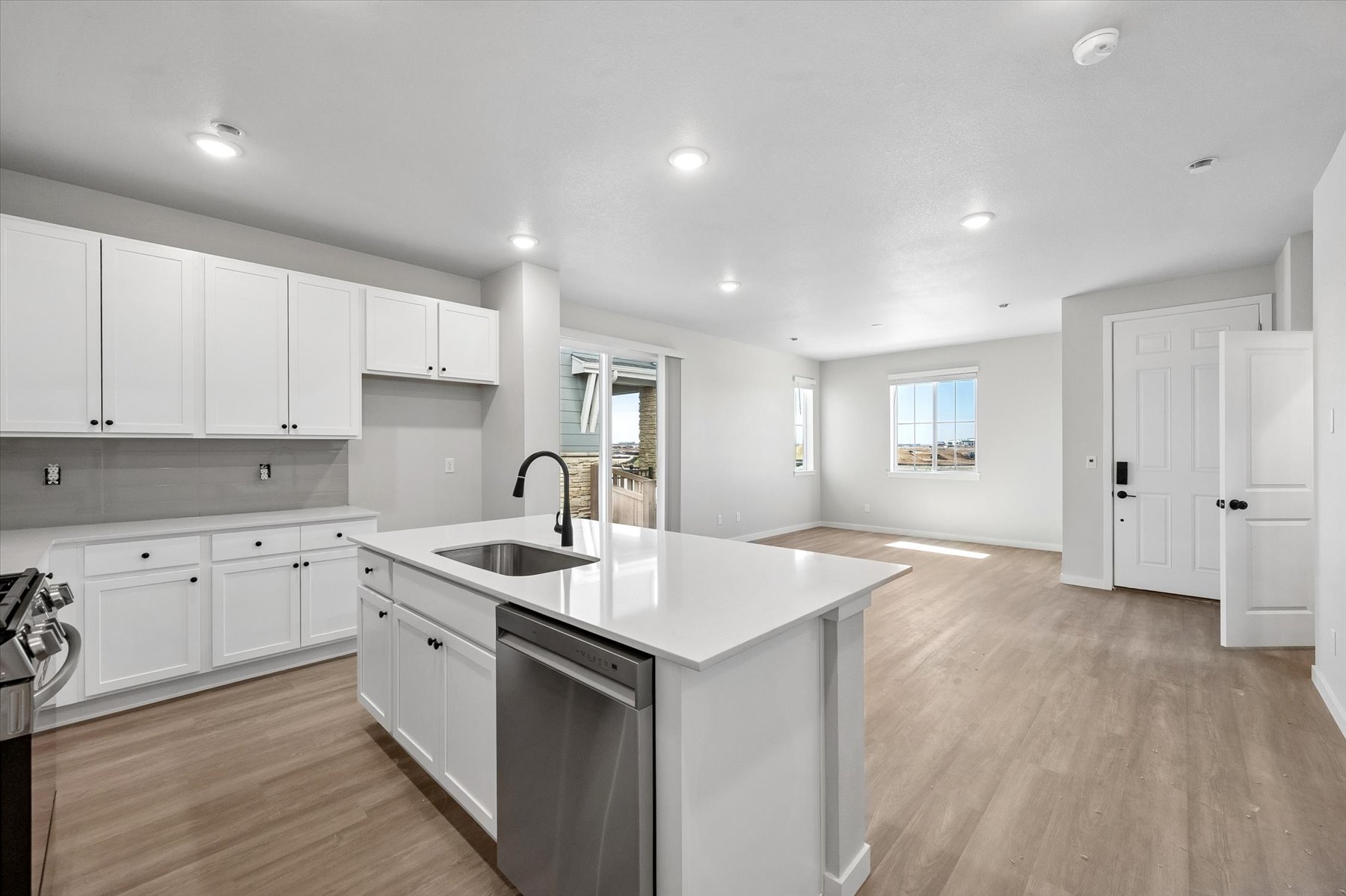 A kitchen with white cabinets.