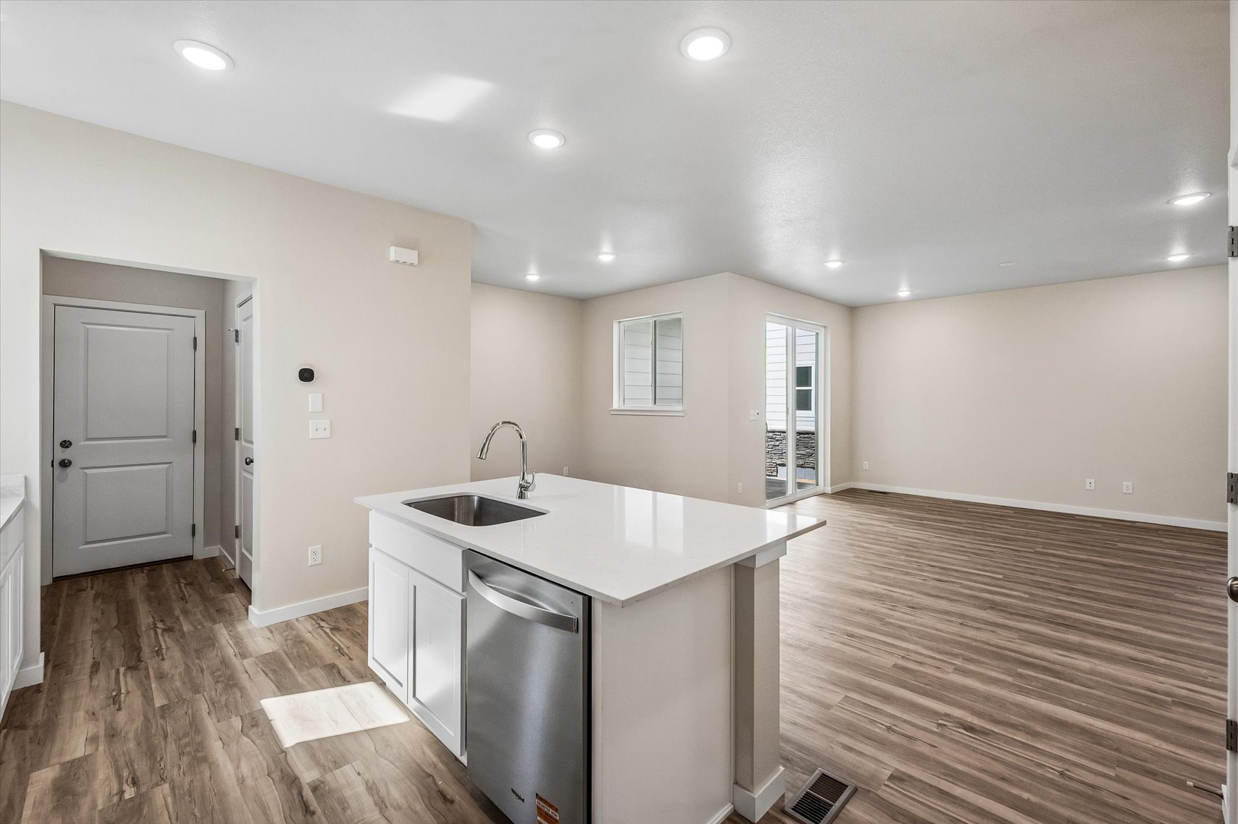 A kitchen with white cabinets.