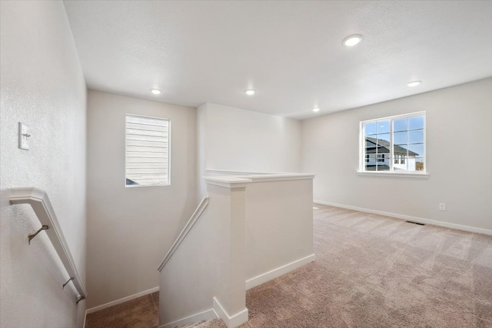 A room with a shower and a window.