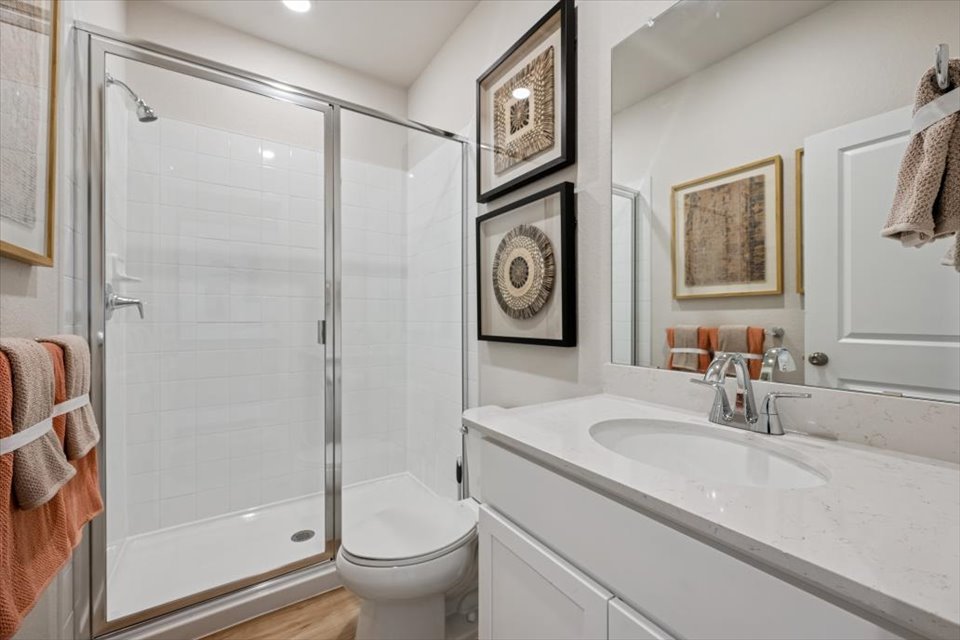 A bathroom with a sink toilet and shower.
