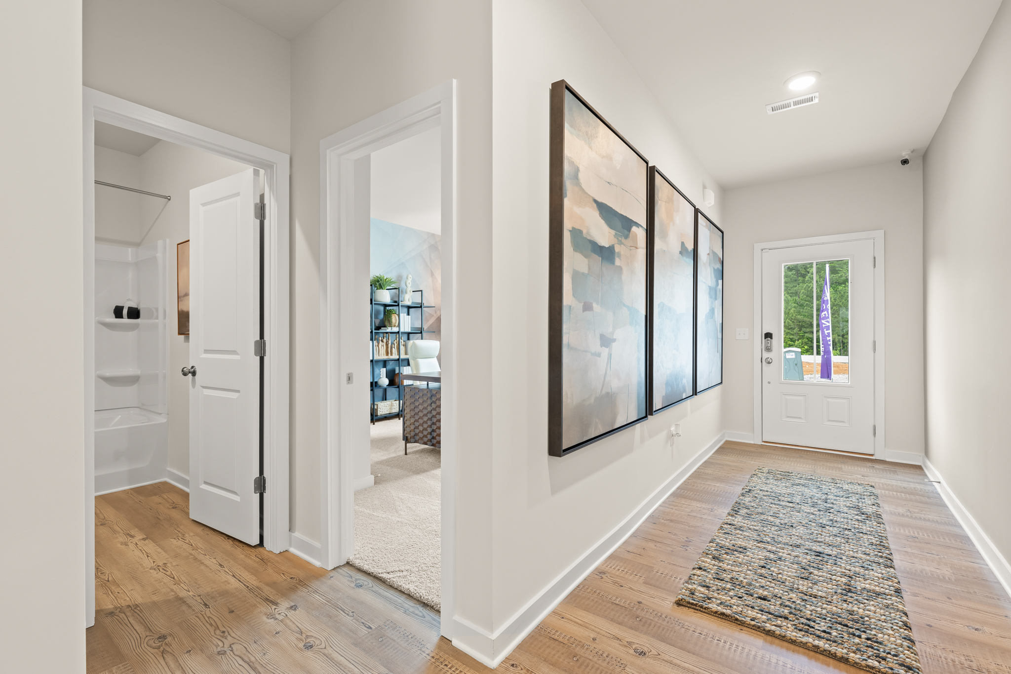 A room with white walls and a rug.