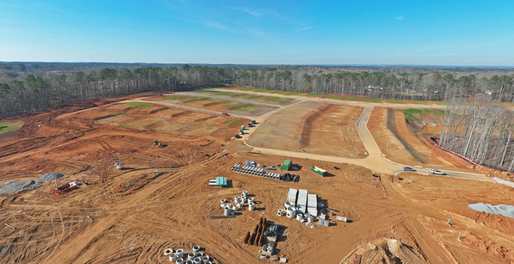 A large dirt field with many buildings.