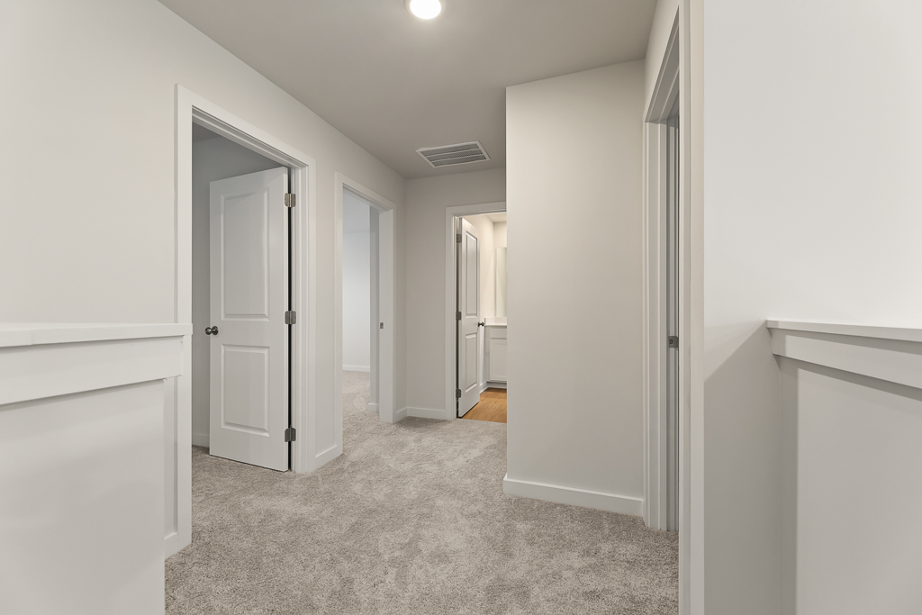 A hallway with white walls.