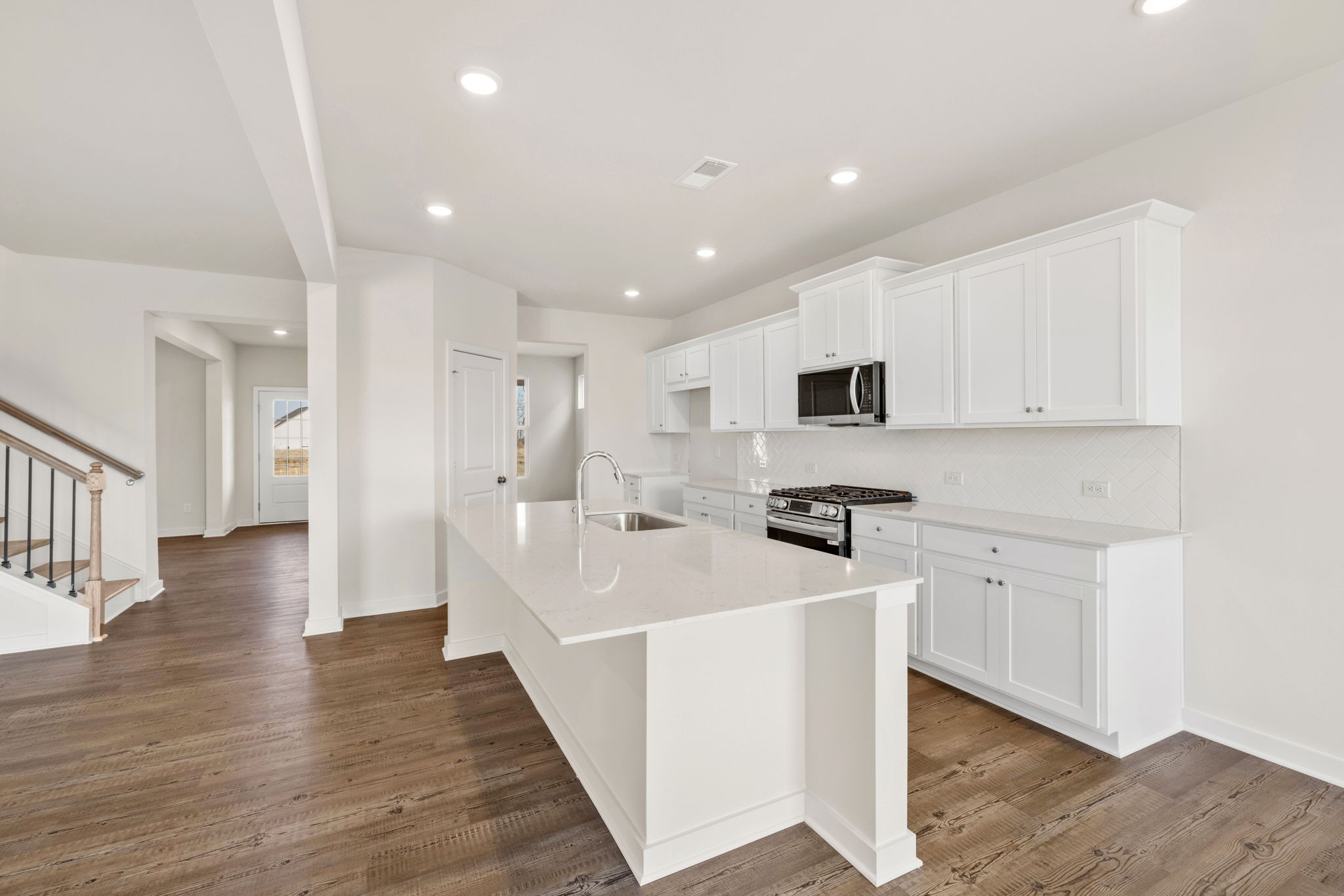 A kitchen with white cabinets.