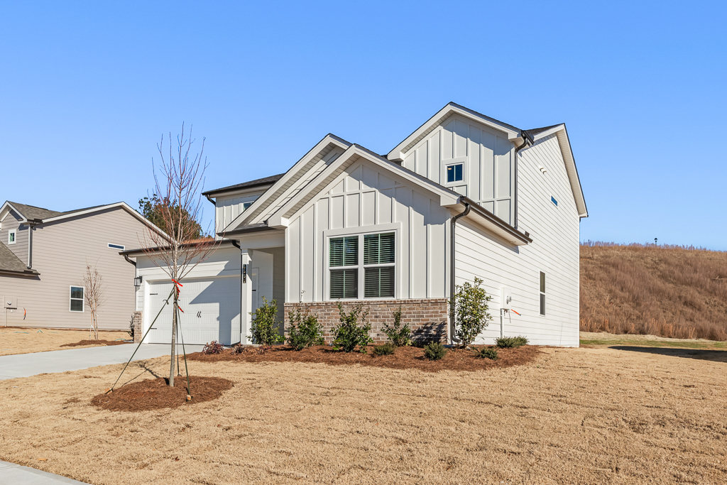 A house with a tree in front.