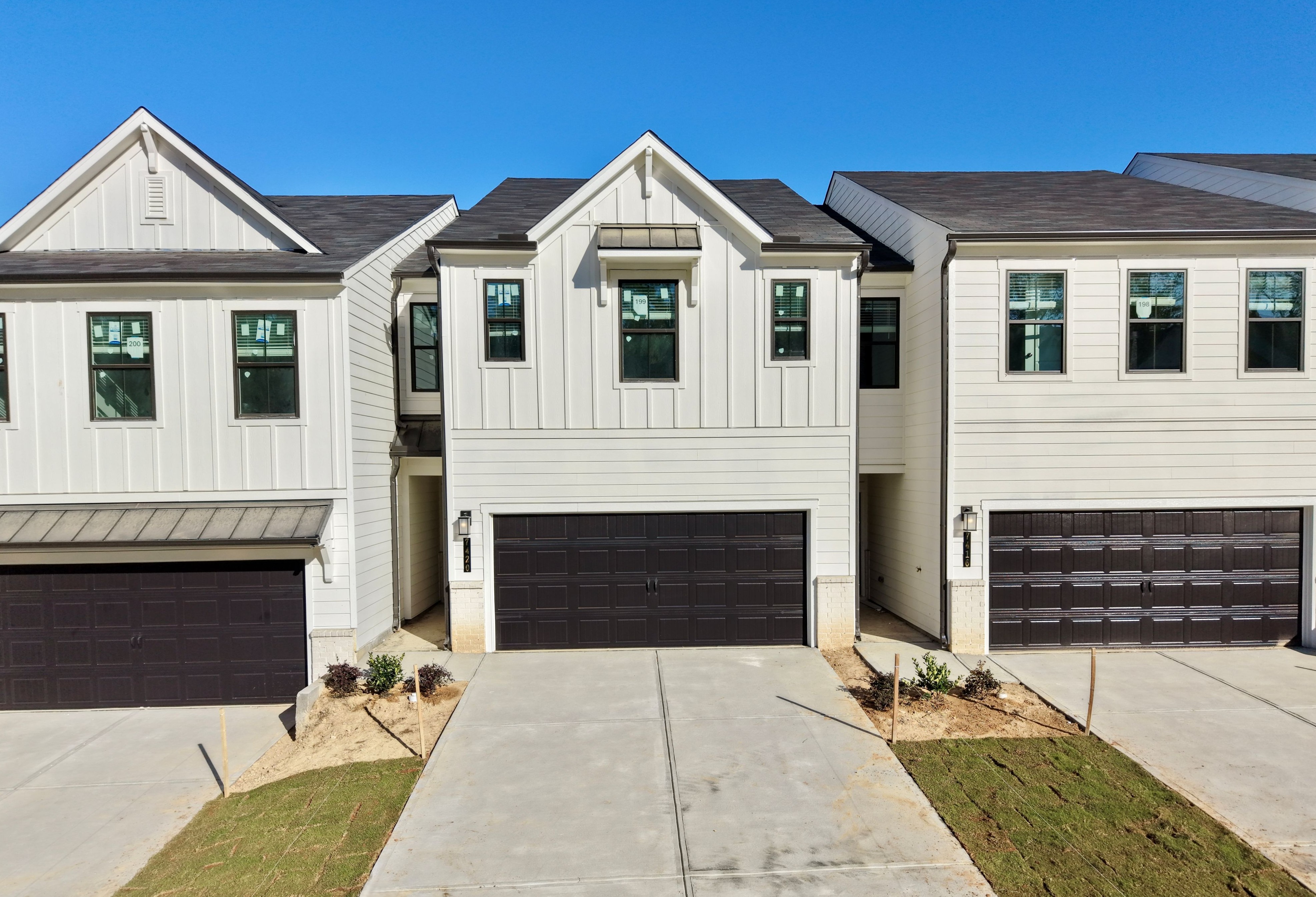 A white house with a garage.