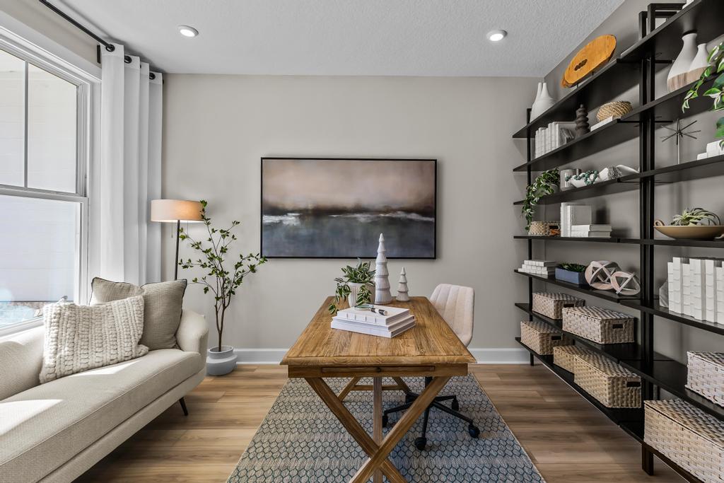 A living room with a table and shelves.