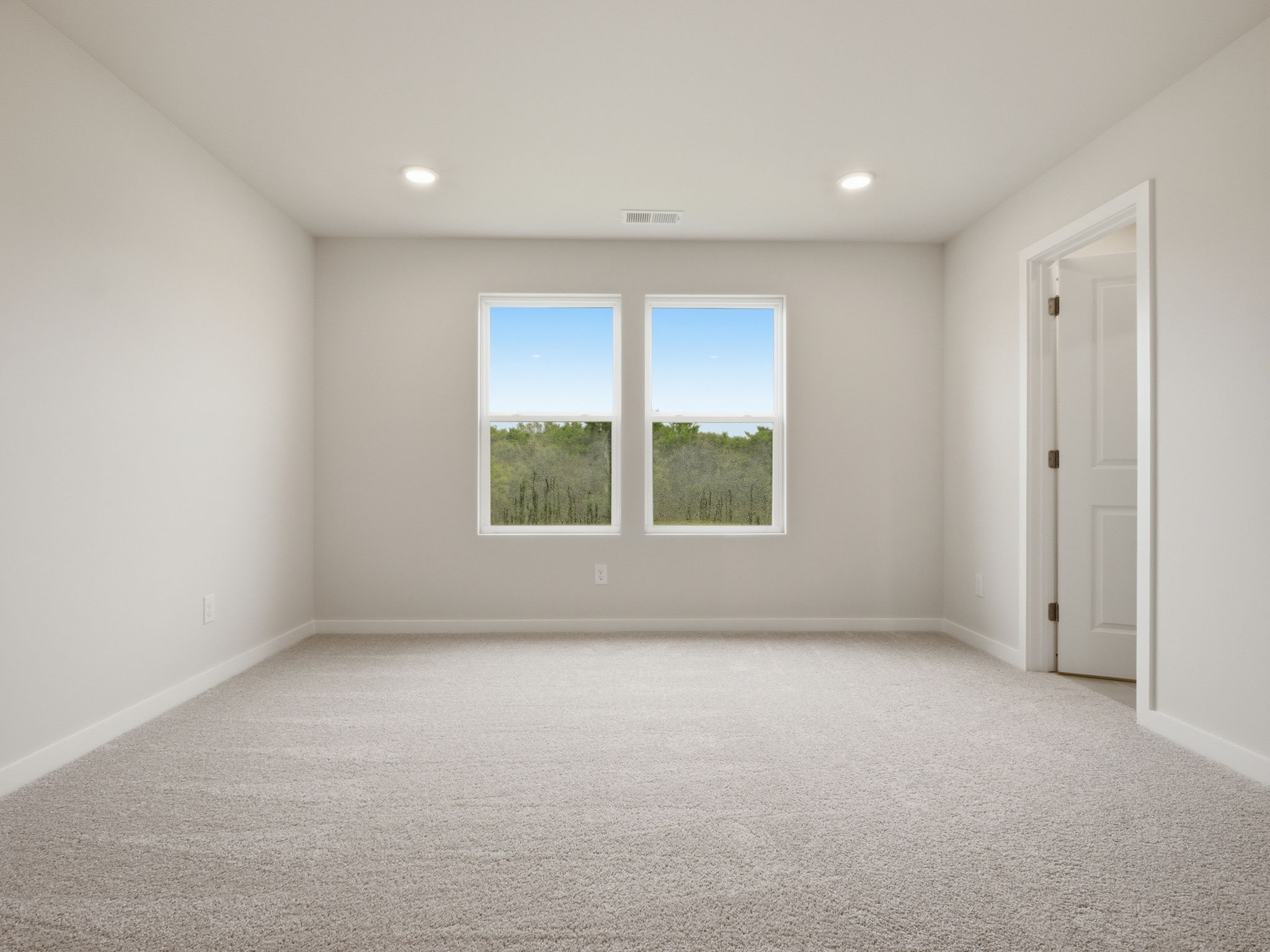 A room with a window and a door.