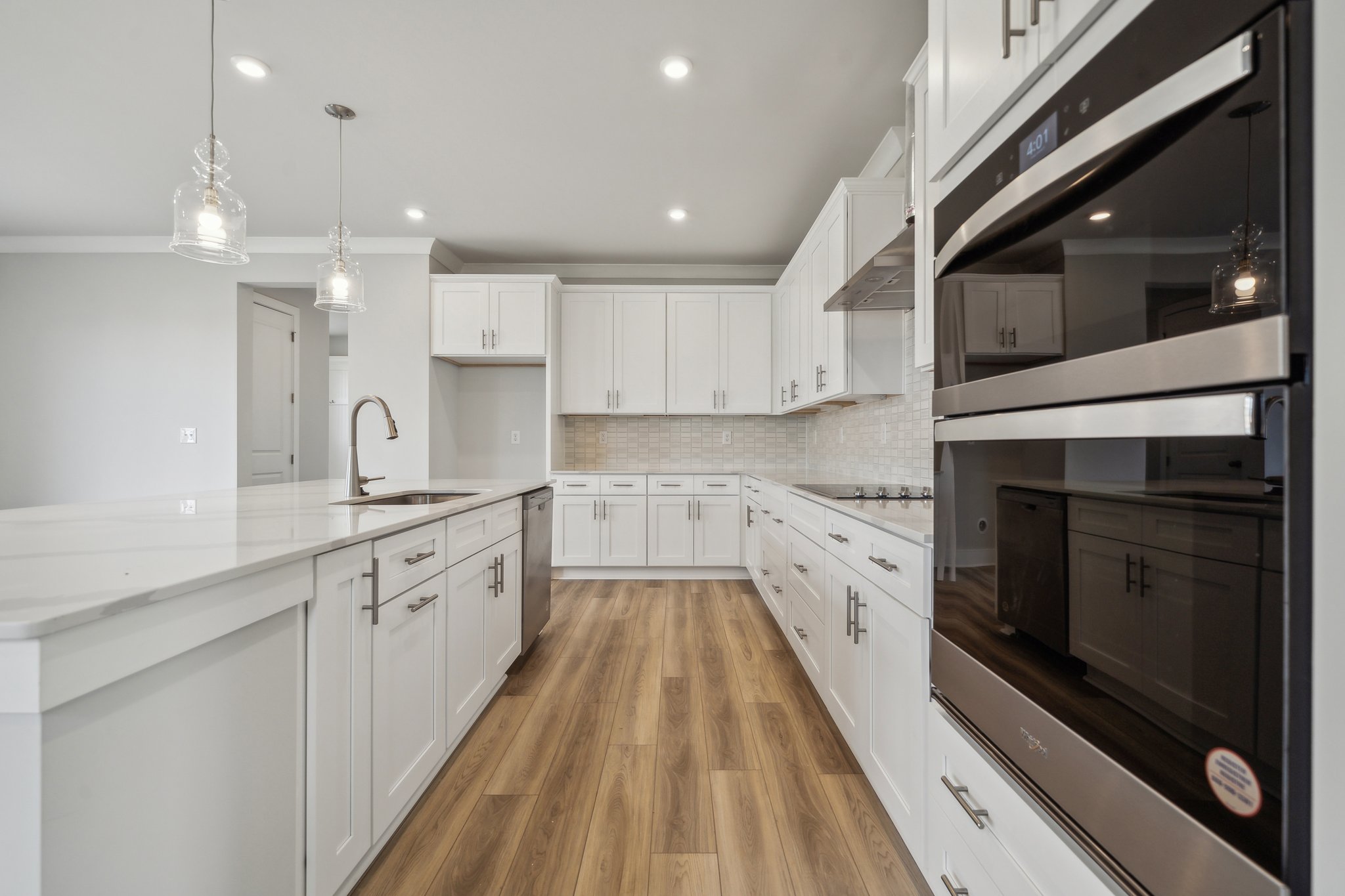 A kitchen with white cabinets.