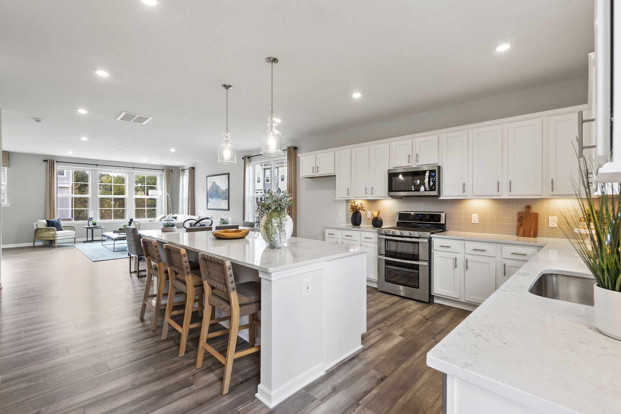 A kitchen with white cabinets.