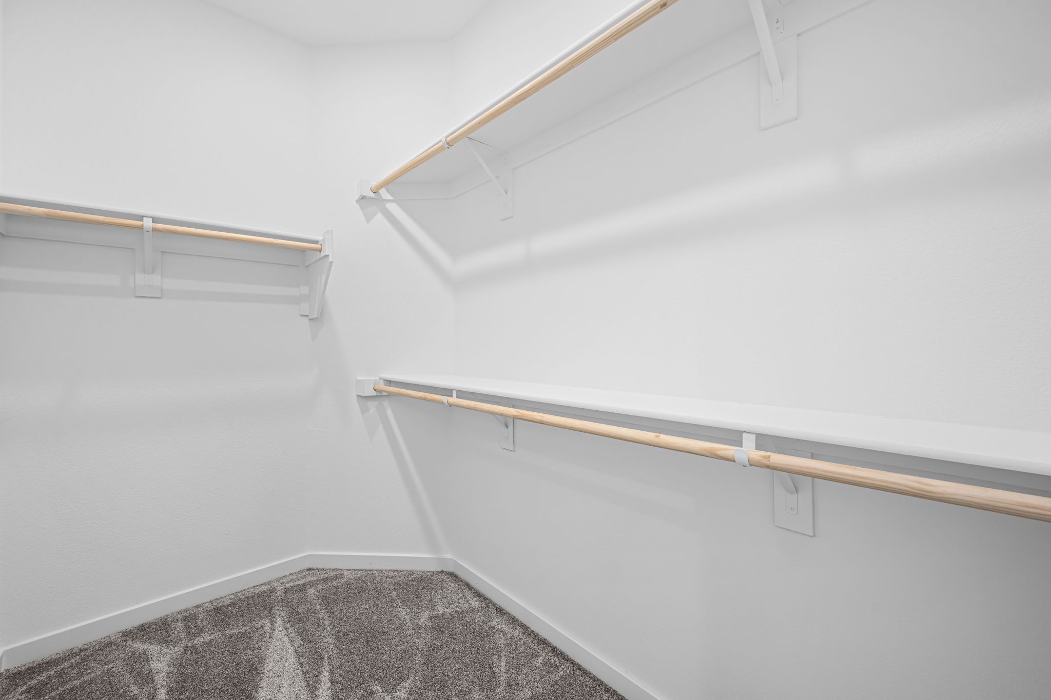 A white wall with a wooden pole.