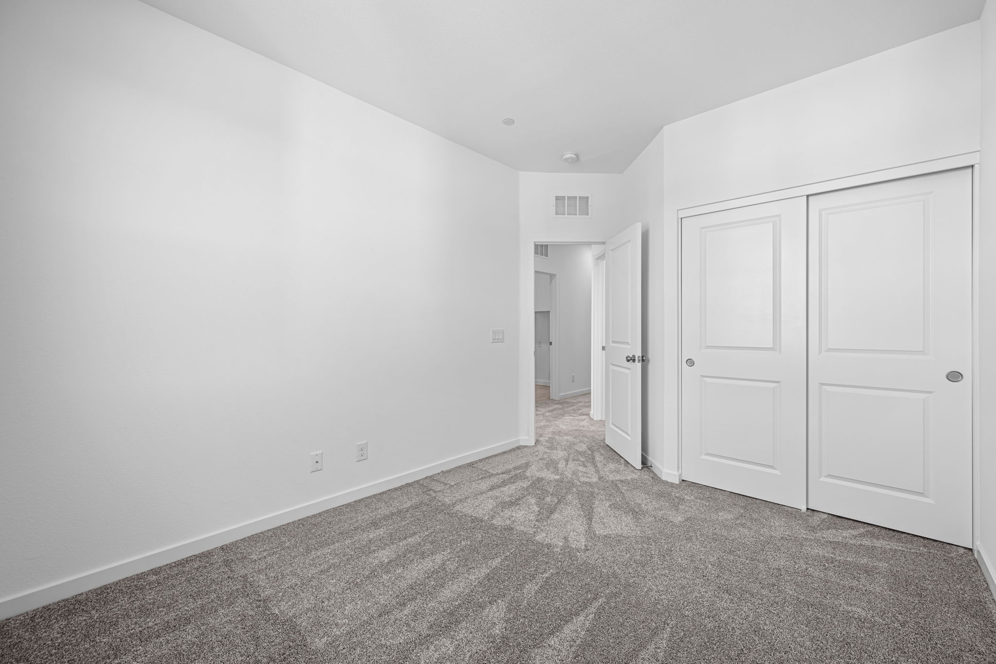 A hallway with white doors.