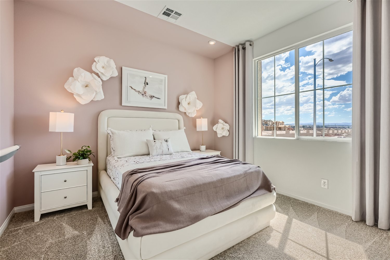 A bedroom with a large window.