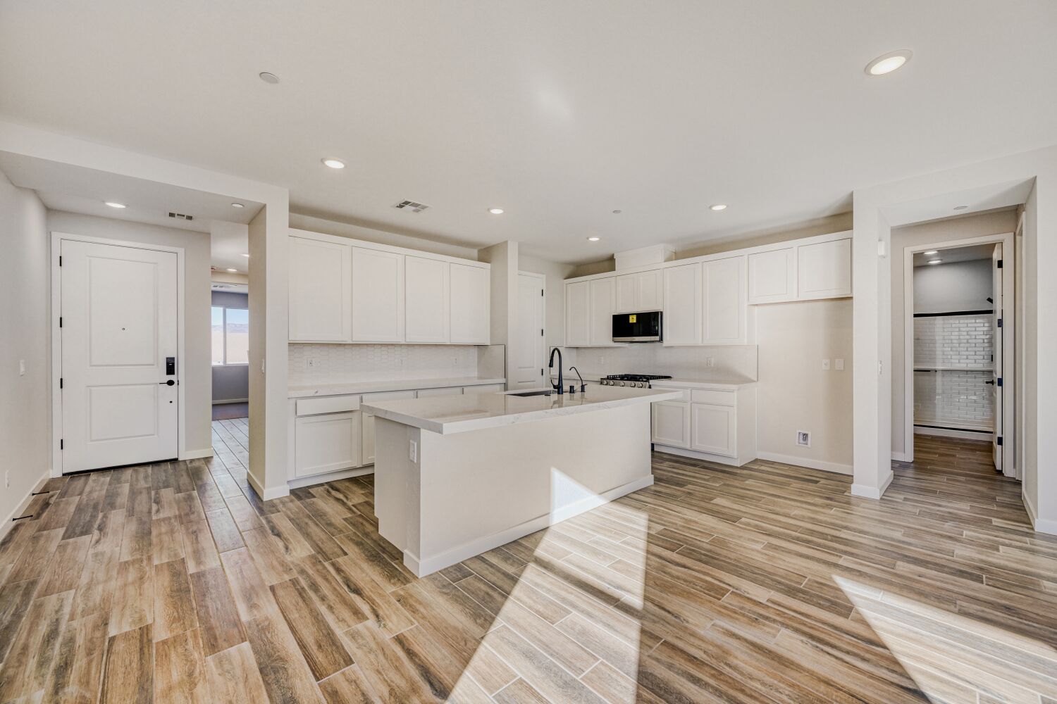 A kitchen with white cabinets.