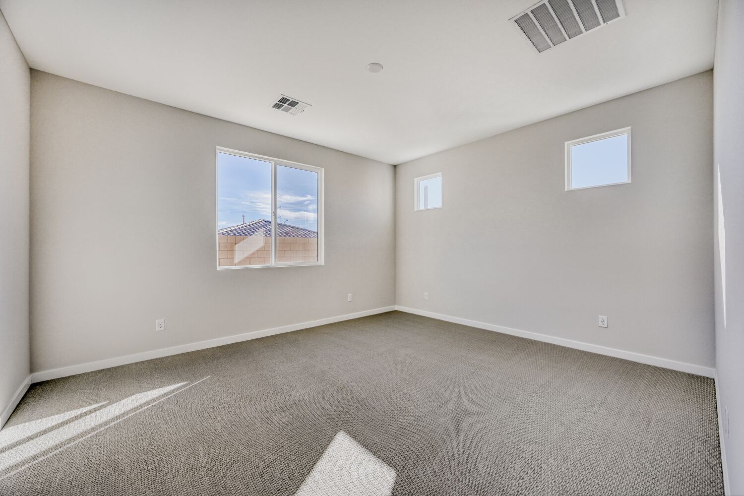 A room with a carpet and a rug.