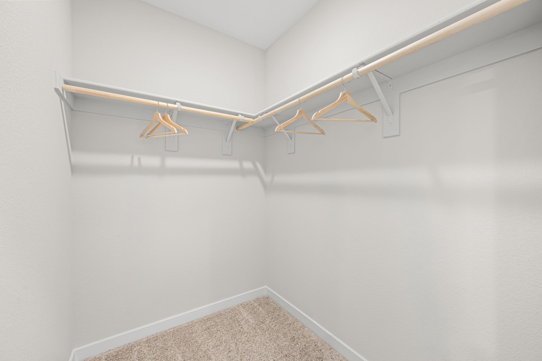 A white wall with a metal bar.