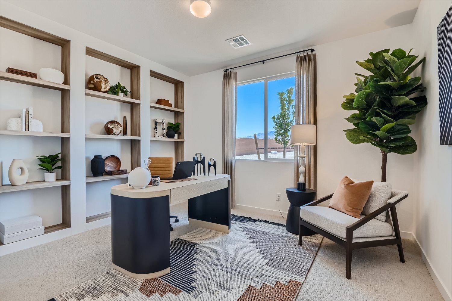 A room with a desk and shelves.