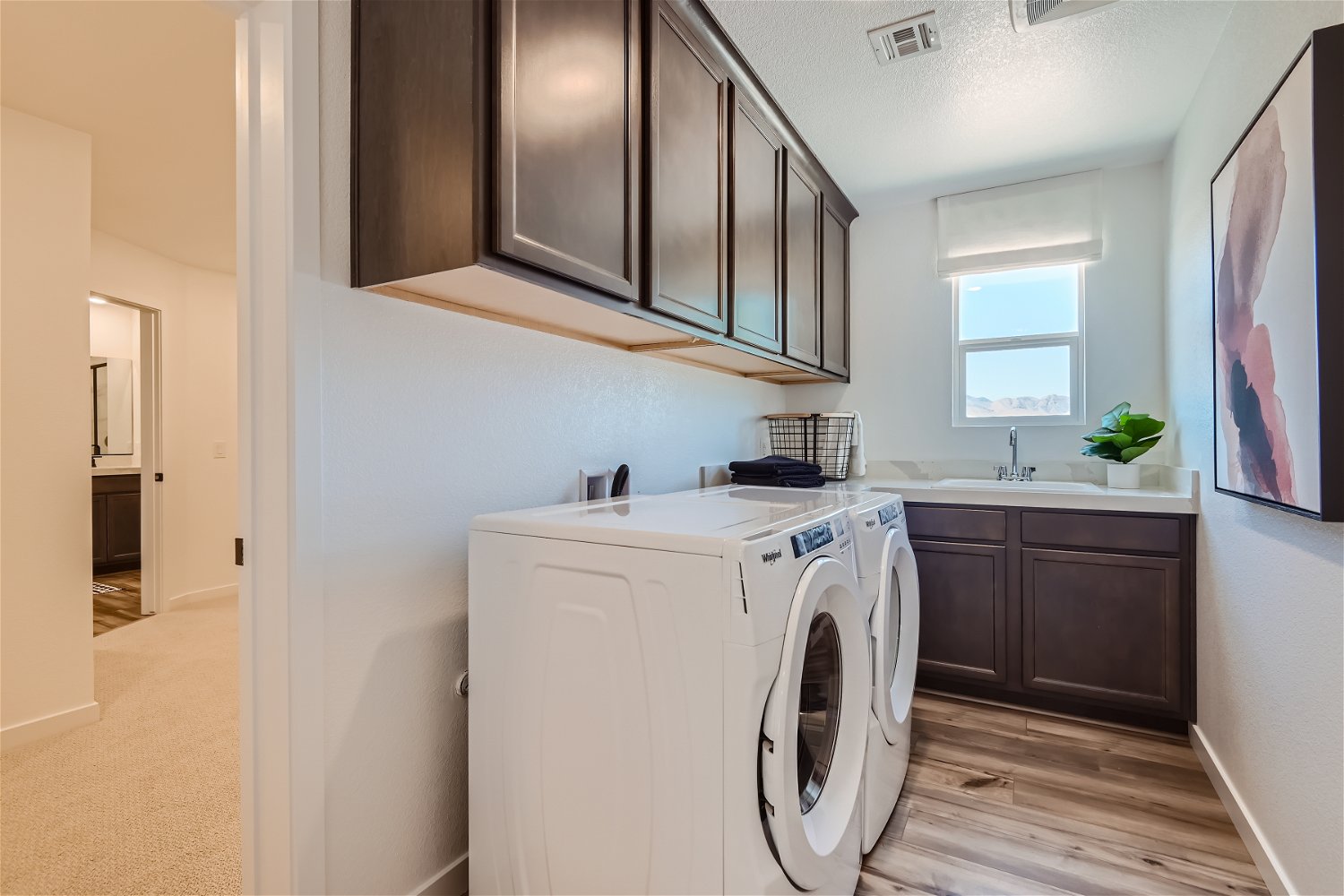 A kitchen with white cabinets.