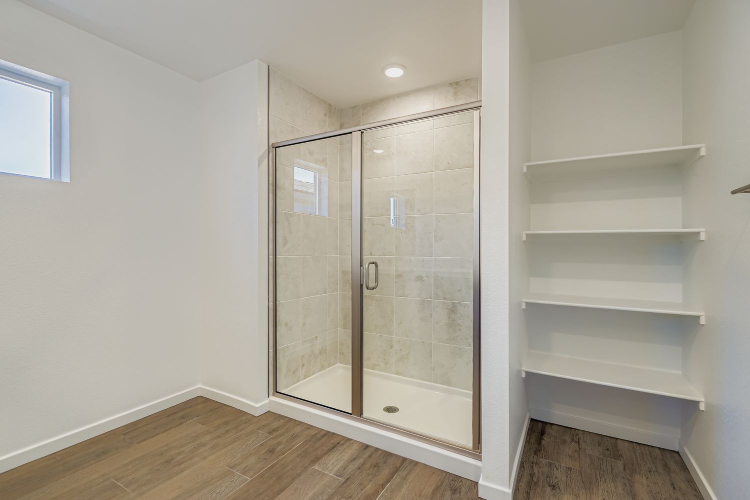 A glass shower in a room.
