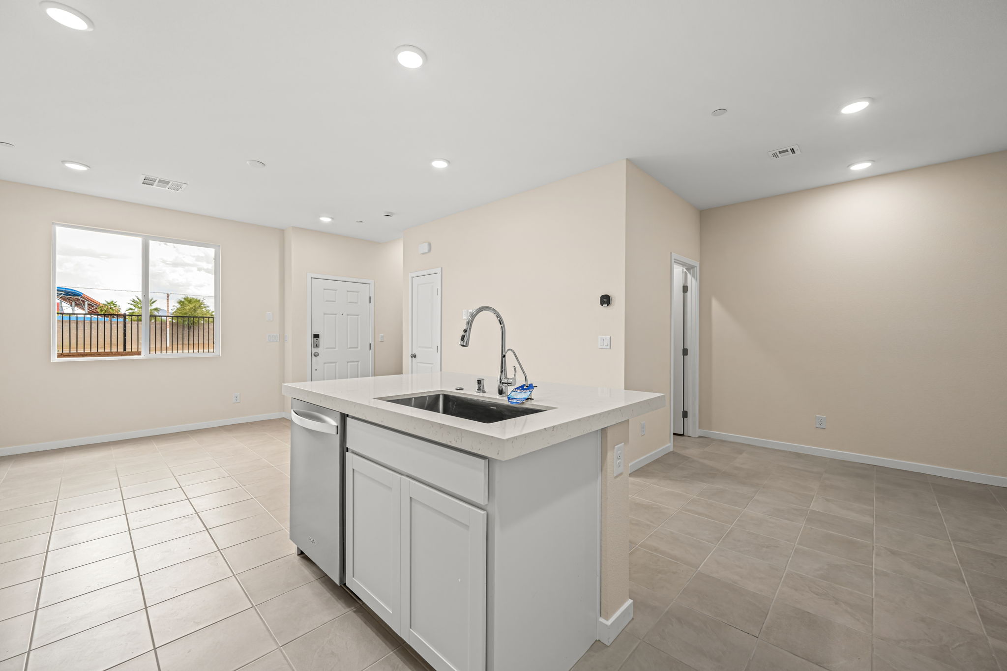A kitchen with white cabinets.