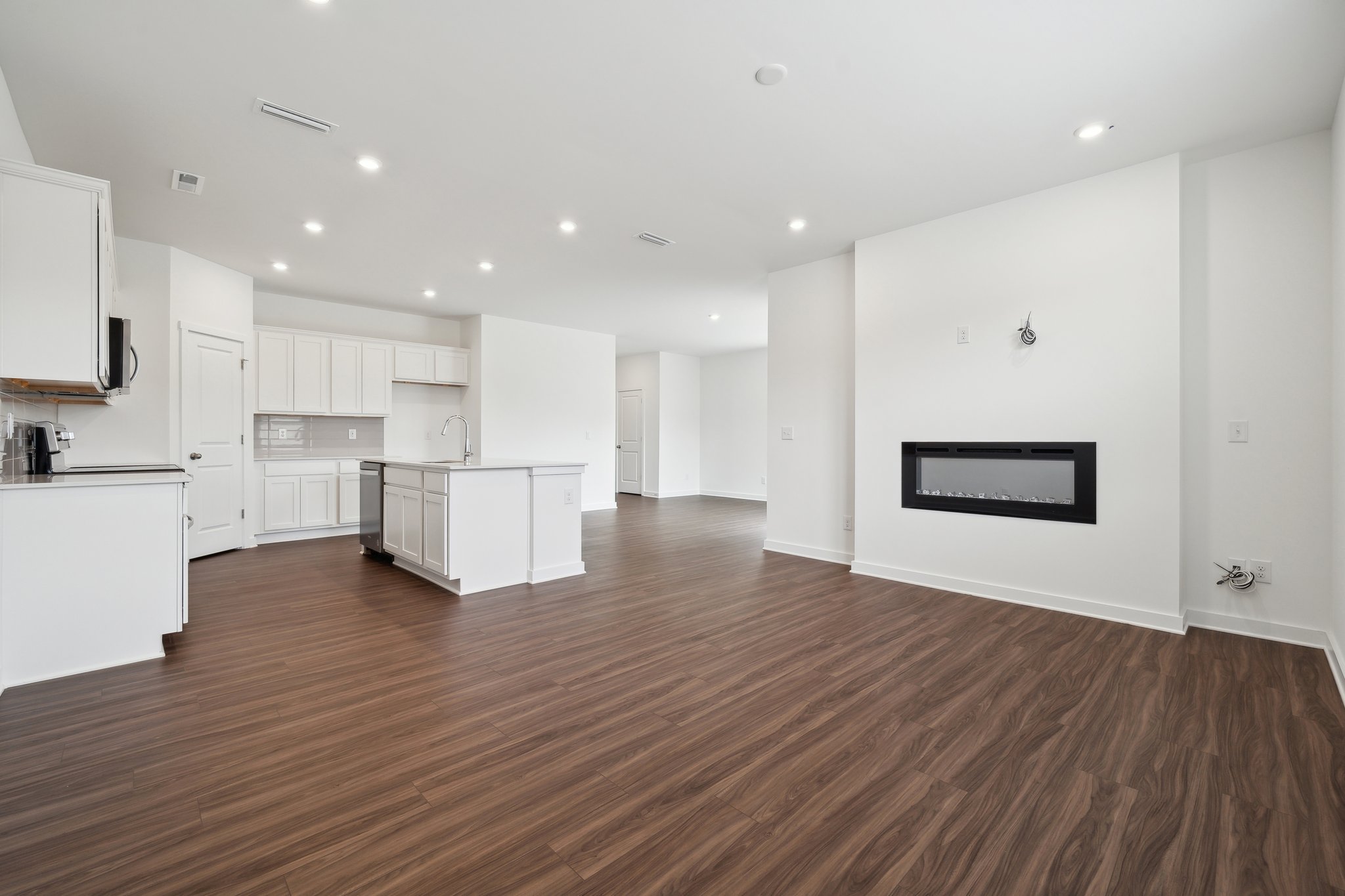 A large kitchen with white cabinets.
