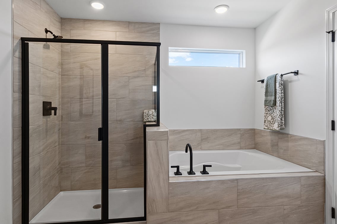 A bathroom with a bathtub and shower.