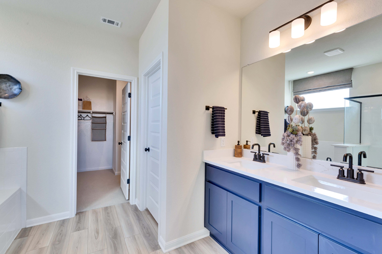 A bathroom with a large mirror.