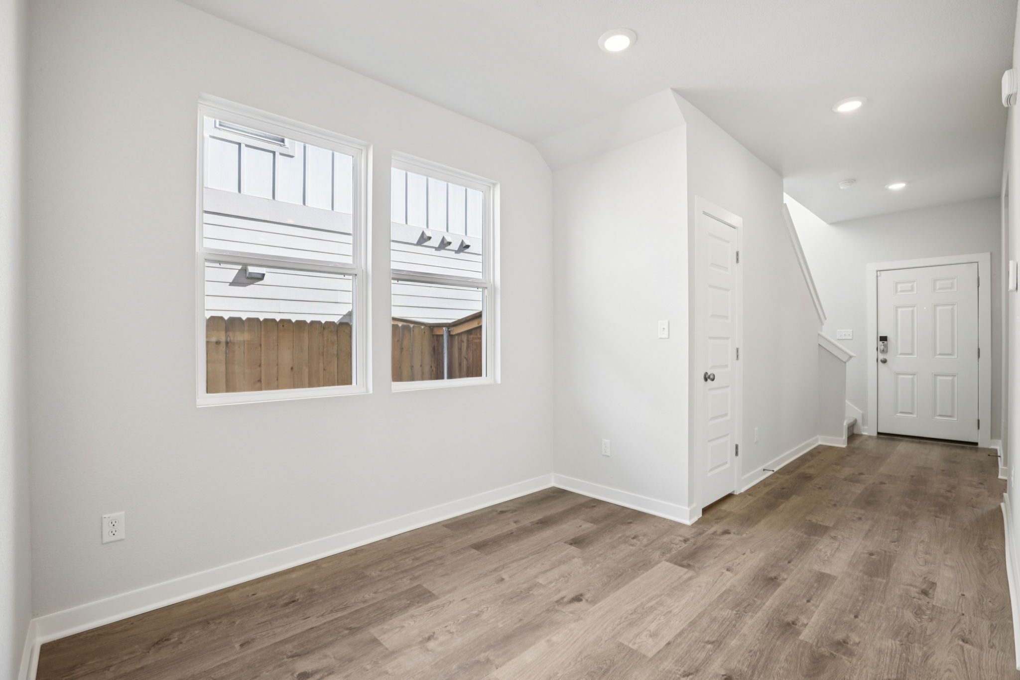 A room with white walls and a wood floor.